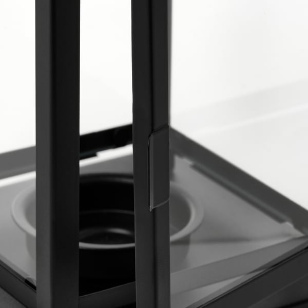 Black metal-framed lantern with clear glass panels, showcasing high-quality craftsmanship and durability.