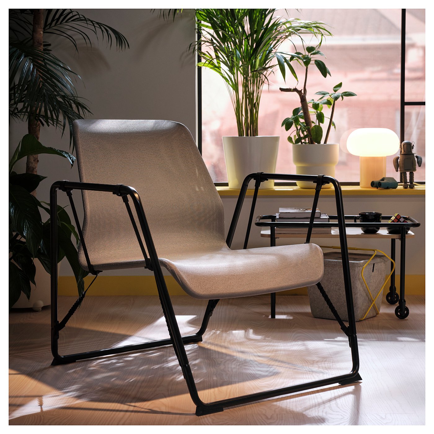 BRÄNNBOLL chair in gray mesh, black metal near window.