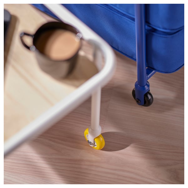 Close-up of a sturdy gaming side table, featuring a yellow wheel with a blue frame on a wooden floor.