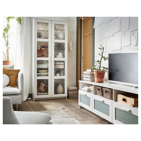 White BRIMNES storage cabinet, featuring glass doors and wooden shelves, perfect for displaying and protecting items.