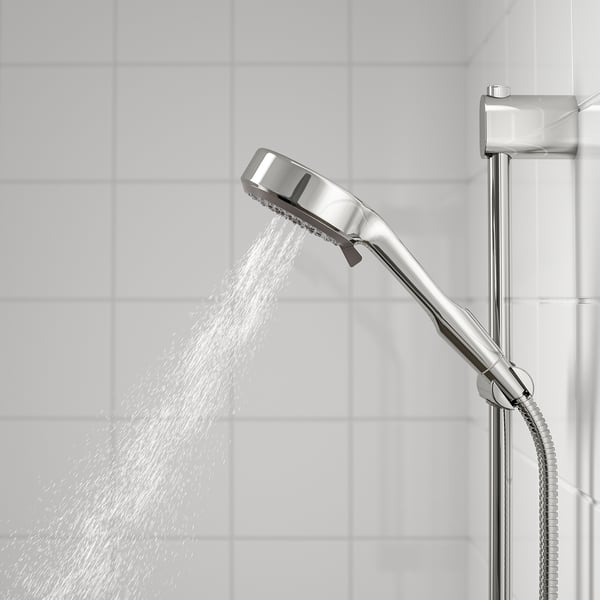 Shower head spraying water, attached to a holder, offering full spray.