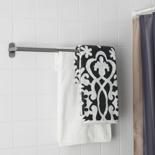 A bathroom towel rack with a white towel and a black and white patterned towel hanging. Stainless steel, clean, and minimalist design.