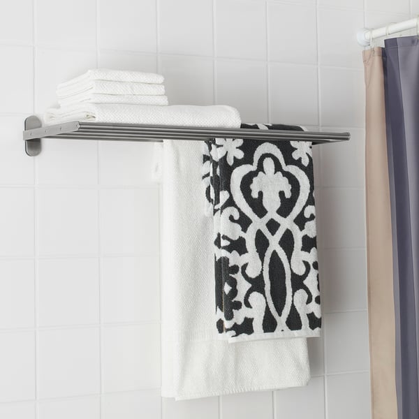Towel rail with shelf stores towels neatly and saves space in the bathroom.