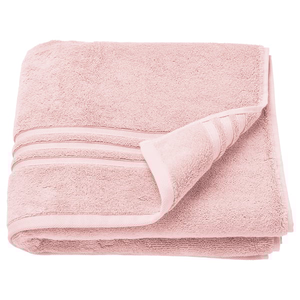 Folded light pink organic cotton towels with a textured design and decorative border. Perfect for bath use.
