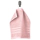 A light pink organic cotton towel hangs on a wall hook. Soft, absorbent with a woven border.