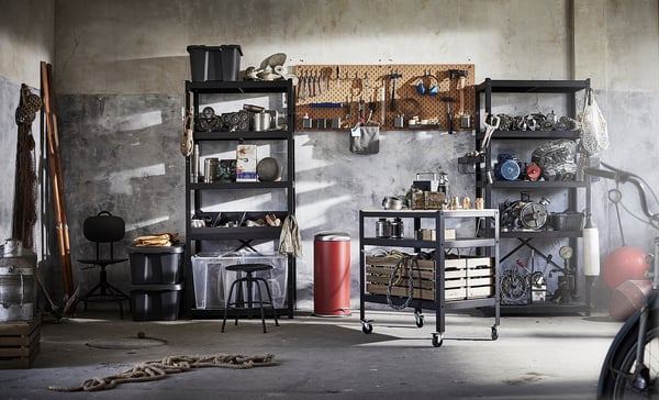 Black BROR shelving units with tools and items, epoxy steel, ropes, buckets, and locked stool.