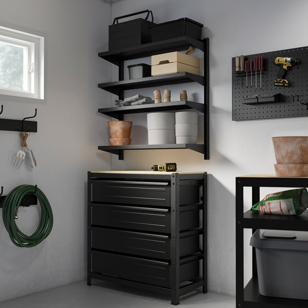 Black BROR storage unit, featuring drawers and shelves, holds various tools and items in a small space.