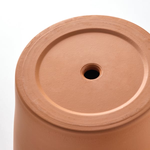 Close-up of terracotta pots saucer with drainage hole. High-quality terracotta with smooth finish.