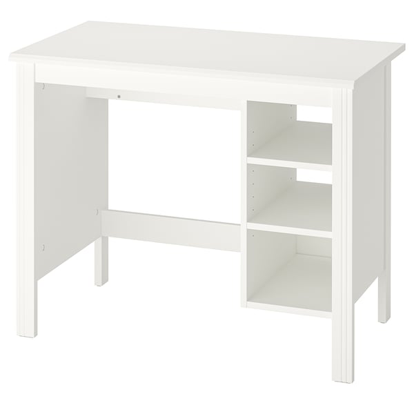 A white BRUSALI desk with a rectangular top, adjustable shelves, and four legs. It has a traditional style with a crafted look.