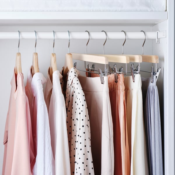 Closet with hanging skirts on BUMERANG clips, keeping clothes neat and wrinkle-free.