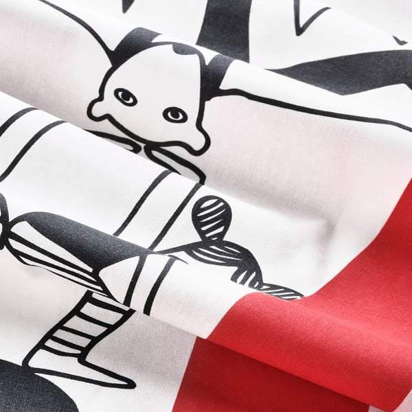 Cartoon circus print duvet cover, white fabric. Soft, whimsical design, rolled neatly.