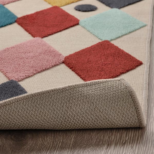Colourful kids rug with soft, raised squares. Rubber back keeps it in place, ideal for play.