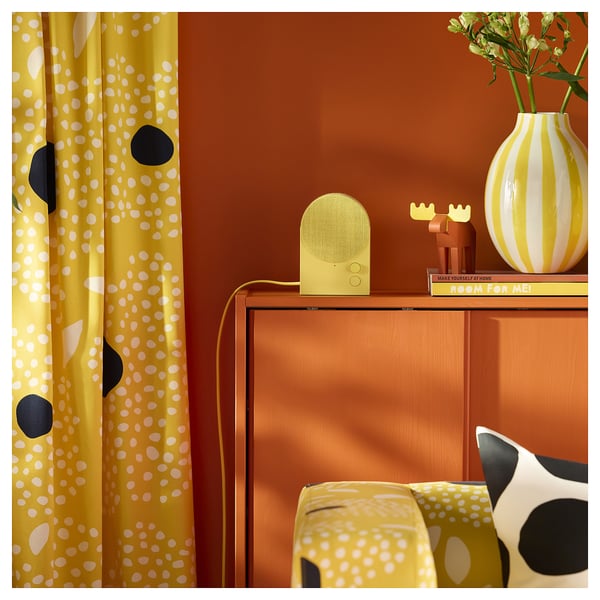 Yellow curtains, orange wall; sideboard, pillow
