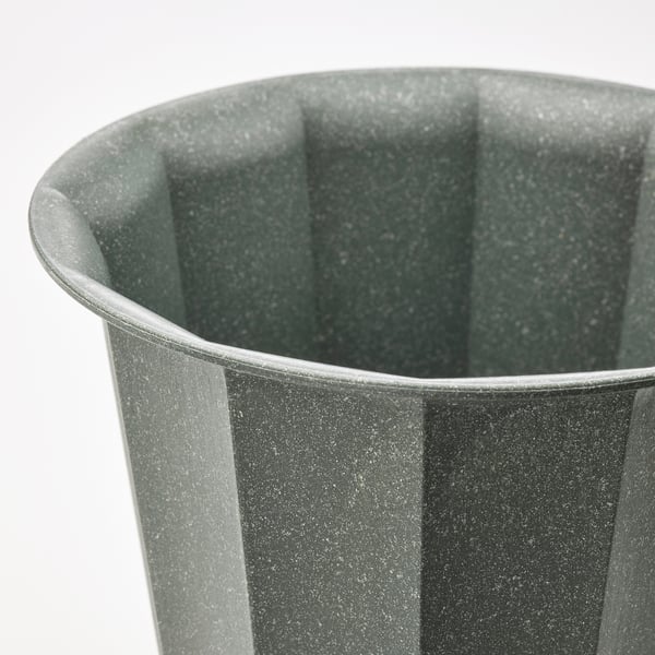 Close-up of a green BUSKVERK planter showing its ribbed texture and durable, recycled material.