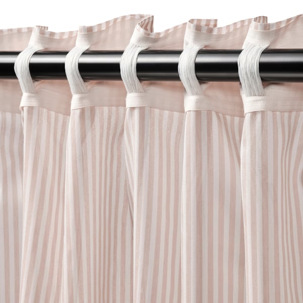 Pink striped curtains with heading tape hang from black rod, creating pleats for a neat look.