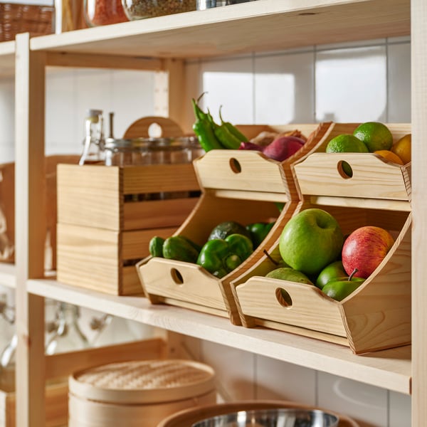 Wooden kitchen organisers hold fruits and veggies, keeping the pantry tidy.