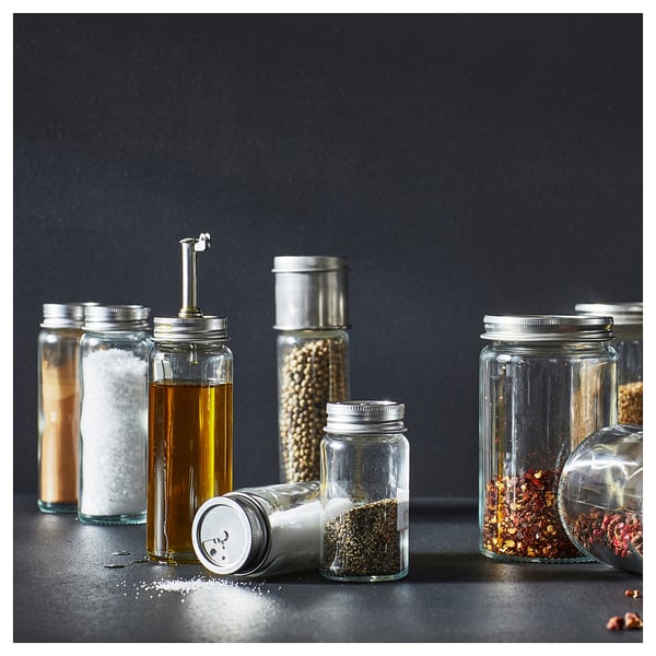 CITRONHAJ glass spice jars of various sizes with stainless steel caps and a silicone seal, arranged on a dark background.