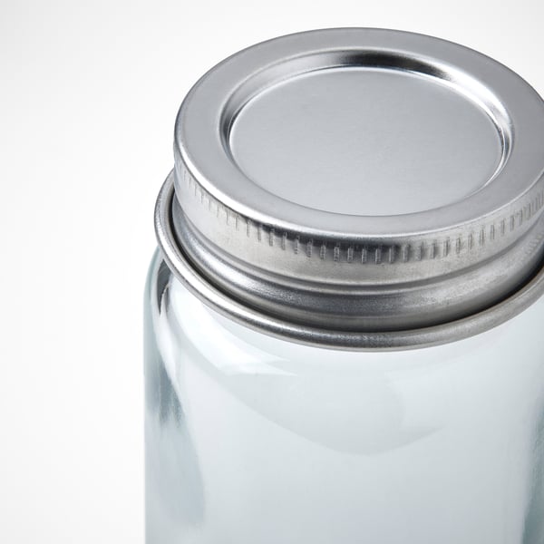 A clear glass jar with a tightly sealed stainless steel lid, featuring a silicone seal for secure closure.