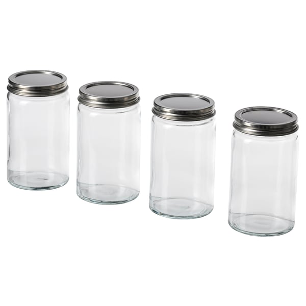 Four empty glass jars with silver lids lined up. Clean, minimalist design. Perfect for storing spices or other kitchen items.