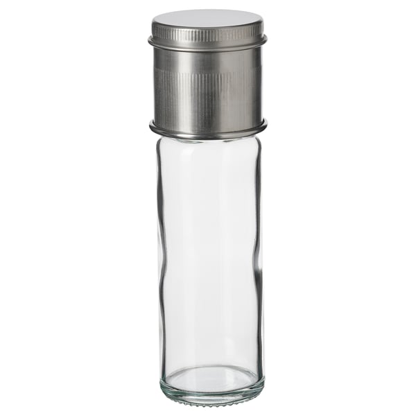 A CITRONHAJ spice jar with a clear glass body, silver metal lid, and ceramic grinder top. Its cylindrical and simple in design.