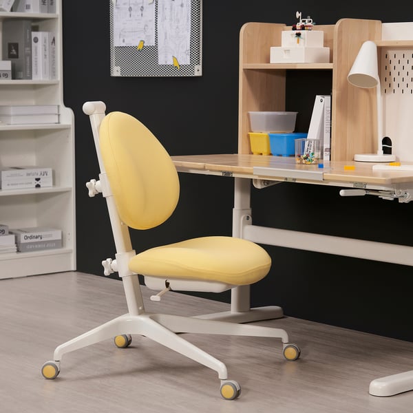 Adjustable yellow DAGNAR chair with wheels at wooden desk.