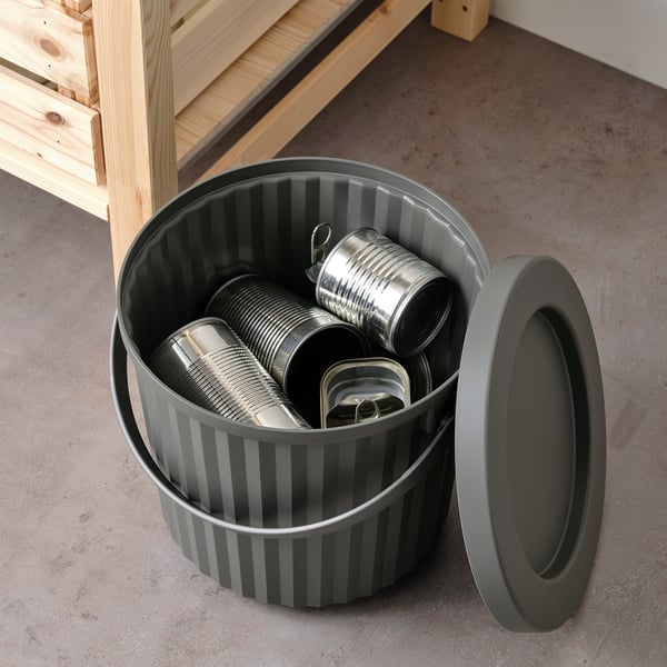 Open striped grey waste bin with lid off, containing metal cans, suitable for small waste like light bulbs or batteries.