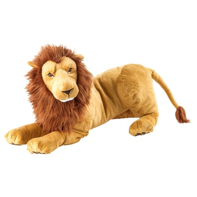 A plush lion toy, beige with brown mane, lying down. Soft, friendly design for kids.