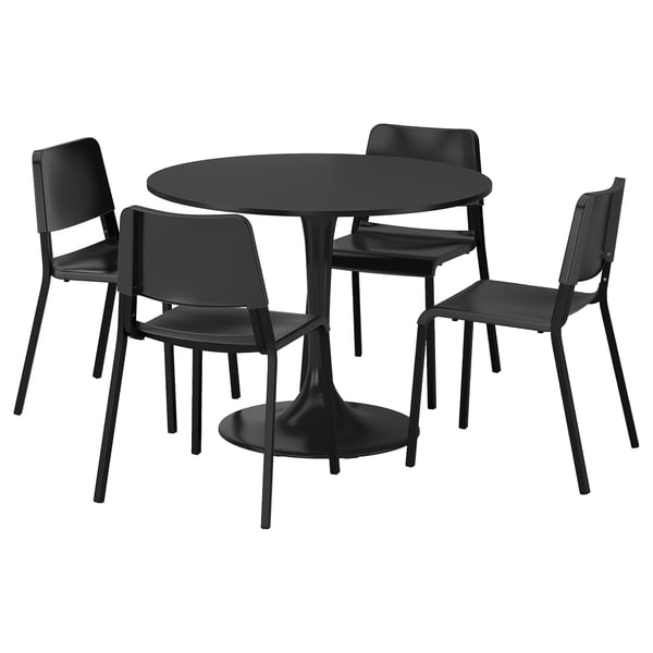 A black DOCKSTA dining set with round table and 4 stackable chairs, metal base, smooth top, modern seats, flexible backs.