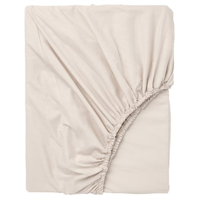 A light beige DVALA fitted sheet made of 100% natural cotton, featuring elastic edging and a soft, wrinkled design.