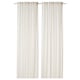 White linen curtains hang straight, offering privacy with sheer fabric.