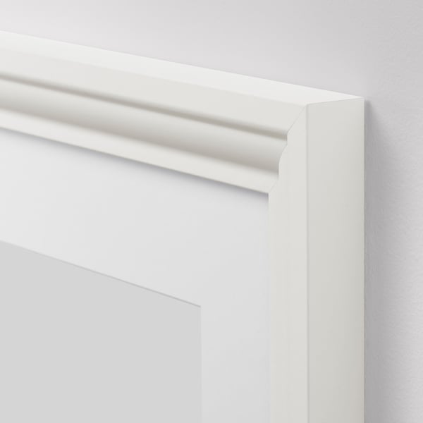 Close-up of a high-quality, white picture frame edge with smooth, elegant lines.