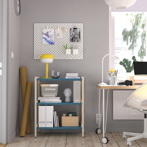 Home office with EKENABBEN shelf, desk, lamp, & pegboard.