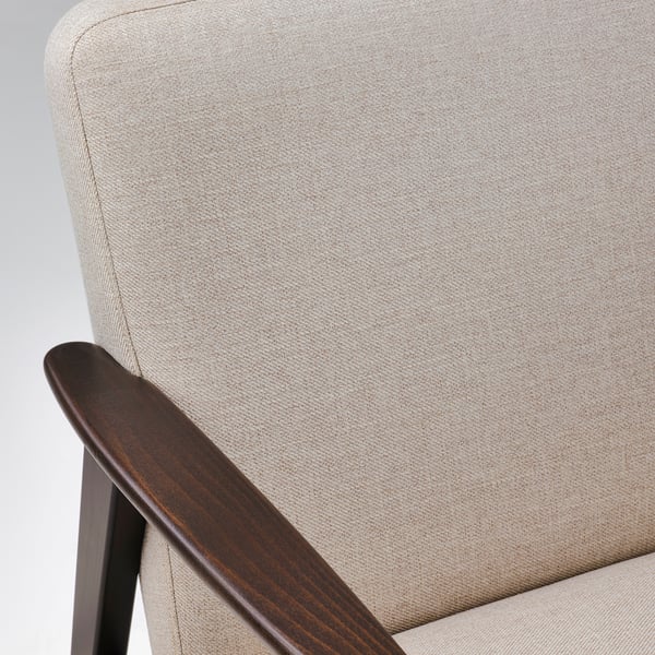 Beige upholstered chair with dark wooden armrests & legs, showcasing high-quality materials & craftsmanship.