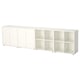 An EKET storage unit in white, featuring closed and open compartments for versatile organization. Modern and minimalist design with adjustable feet.