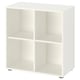 A white EKET storage unit with four open compartments, made of particleboard and fiberboard, standing on adjustable feet.