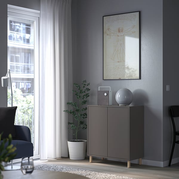 Modern room with grey EKET cabinet, speaker, plant, leonardo da vinci artwork.