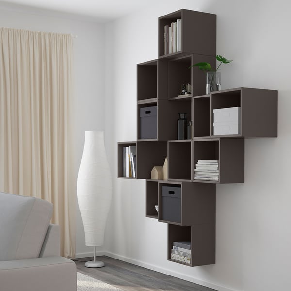 Wall-mounted shelf unit with multiple compartments for books and decor, maximising space.