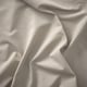 Smooth, luxurious fabric close-up. Soft texture, elegant weave pattern visible.