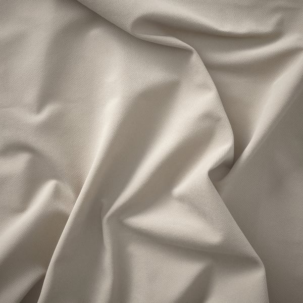Smooth, light-colored fabric; soft texture, likely upholstery or bedding.