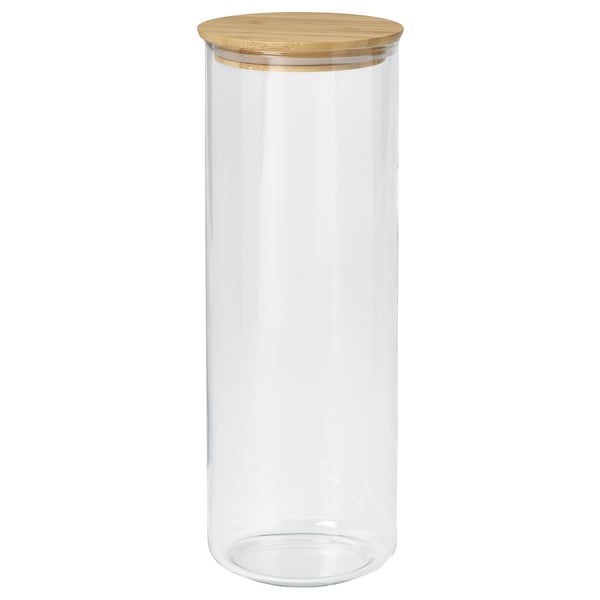 A clear glass jar named EKLATANT with a wooden lid. It is cylindrical, suitable for storing food, and has a simple, elegant design.