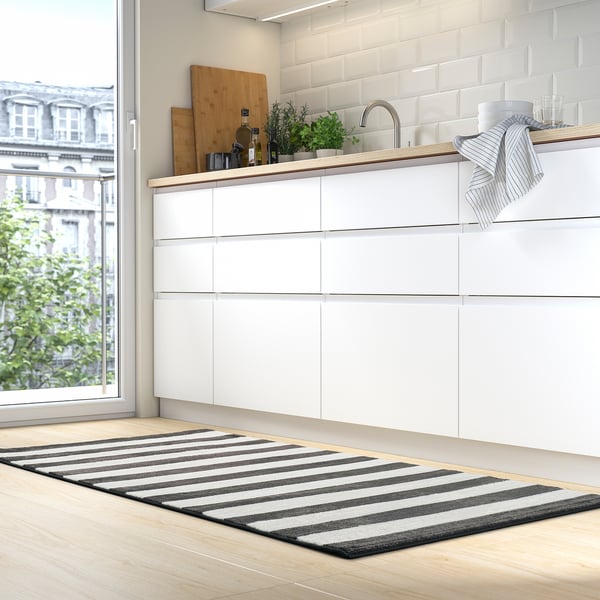 Modern kitchen with white cabinets, large window, striped grey rug, black and white stripes, soft recycled polyester.