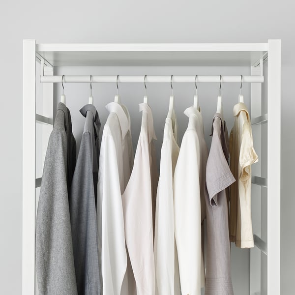 A modern closet in white with clothes hangers; includes rail and hangers, designed to hold around 24-26 shirts.
