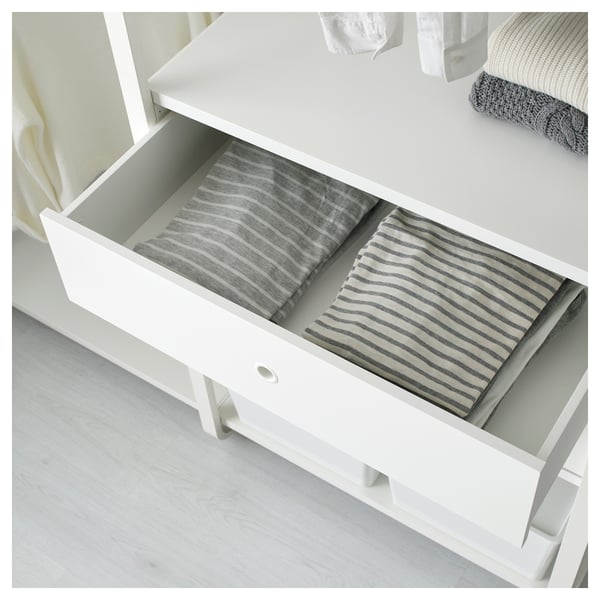 White dresser drawer open, showing neatly folded striped towels or clothes. Part of IKEAs ELVARLI modular storage system.