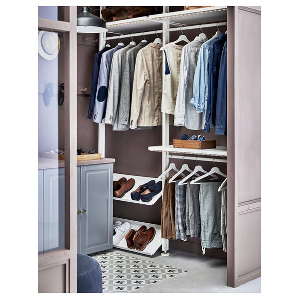 Open closet with clothes on hangers and shelves, organised neatly.