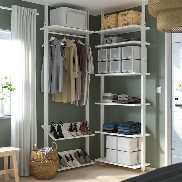 Closet with clothes, shelves, and storage boxes.