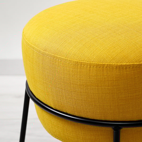 Bright yellow upholstered stool with black metal legs, showcasing quality fabric and sturdy construction.