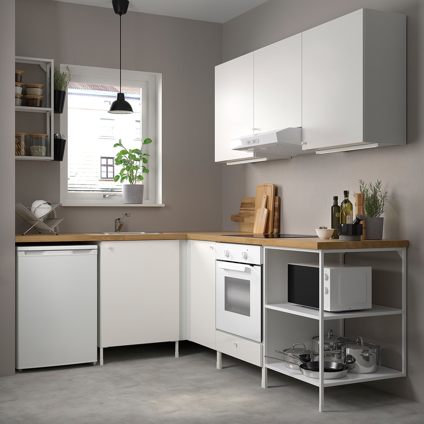 Modern white kitchen: ENHET series. Counters, microwave, stove, sink, and potted plants. Grey walls, concrete floor.
