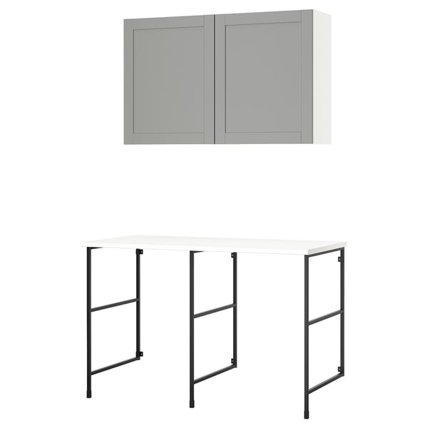 An ENHET storage unit: grey cabinet with two doors, a white countertop with black metal legs, and a clean, modern design.