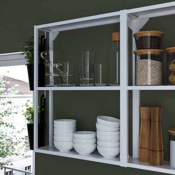 A kitchen shelf with white bowls and glass jars; offers open storage, displaying items neatly.
