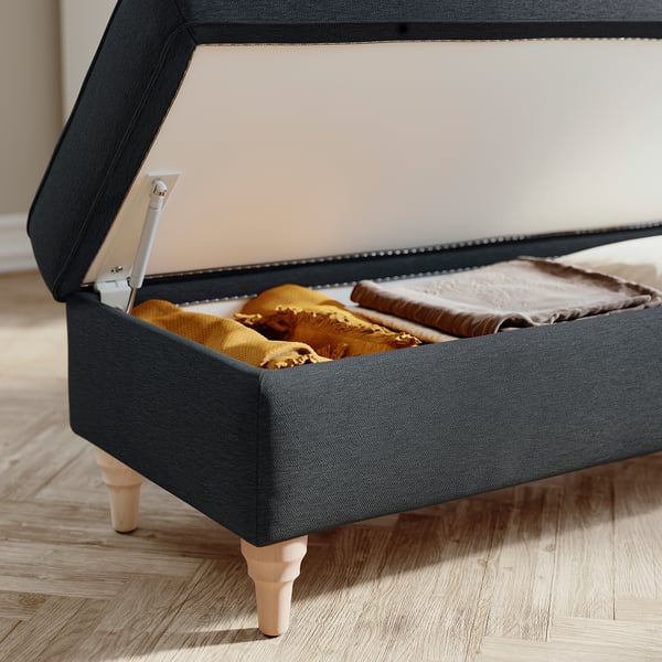 ESSEBODA grey fabric storage bench with wooden legs; opened, showing blankets inside.